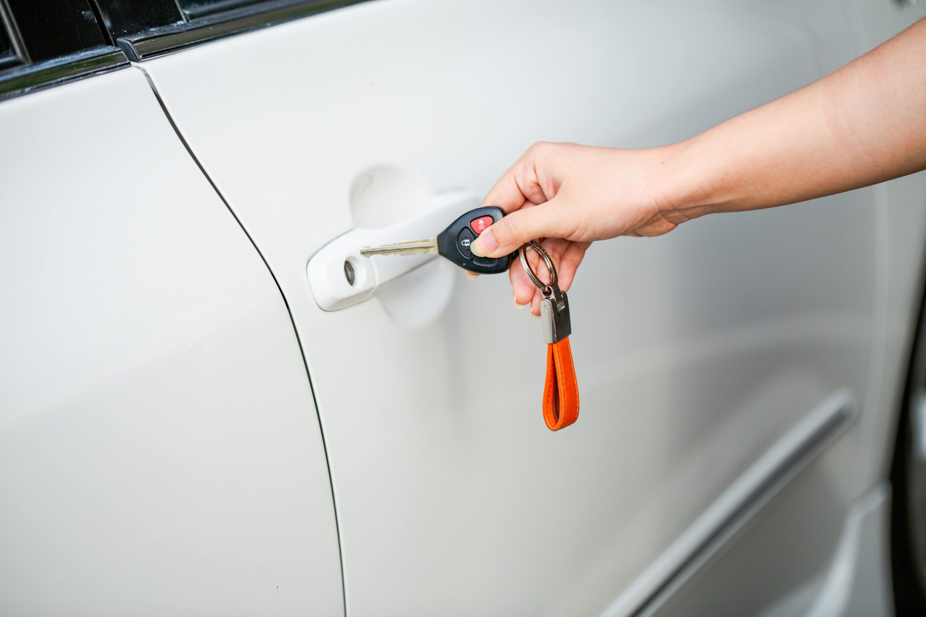 Person inserting key into car door