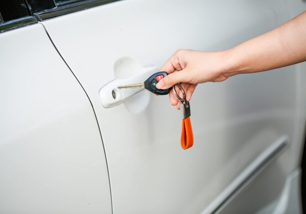 Person inserting key into car door